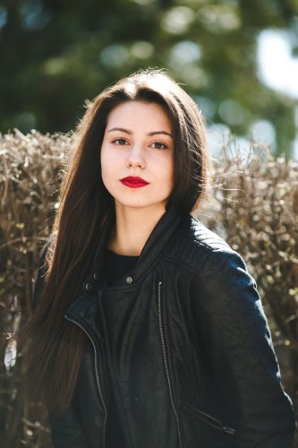 young-beautiful-girl-posing-black-leather-jacket-park.jpg