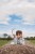 full-length-boy-with-arms-raised-field-against-sky.jpg
